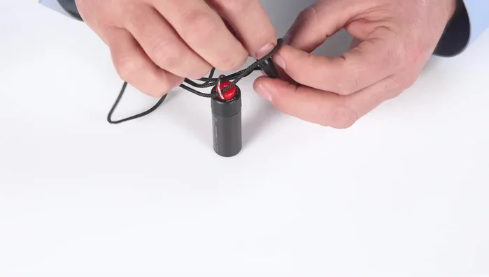 Attach the neck cord using the provided Carabiner.